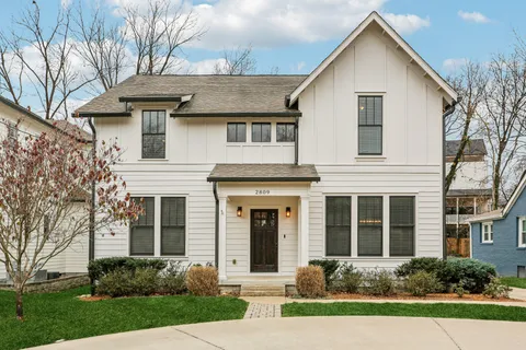 a front view of a house with a yard and porch