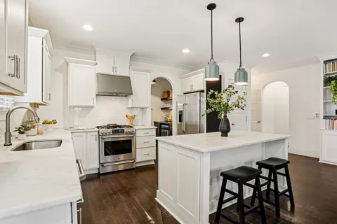 a kitchen with a stove a sink and a refrigerator
