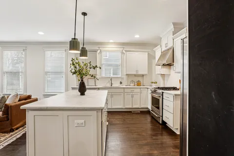 a kitchen with a sink stove and cabinets
