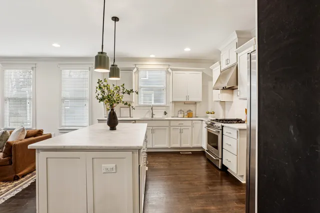 a kitchen with a sink stove and cabinets