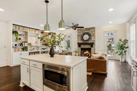 a kitchen with a stove and a wooden floor