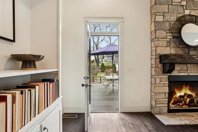 a view of a hallway with wooden floor and a fireplace