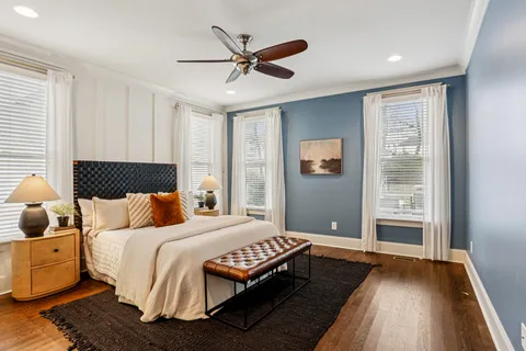 a bedroom with a bed and a large window