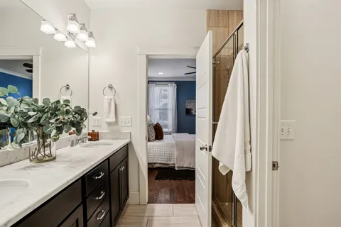 a en suite bathroom with a double vanity sink and a mirror
