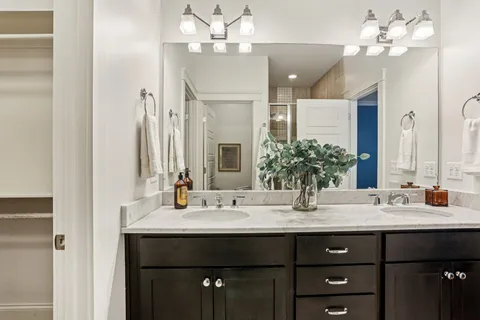 a bathroom with a sink double vanity and a mirror