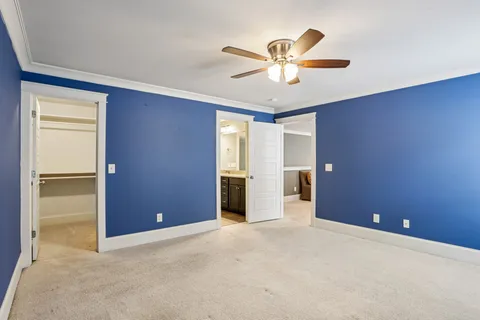 an empty room with closet and fan