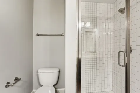 a bathroom with a toilet and a shower