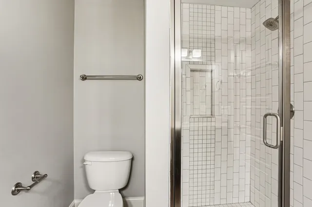 a bathroom with a toilet and a shower