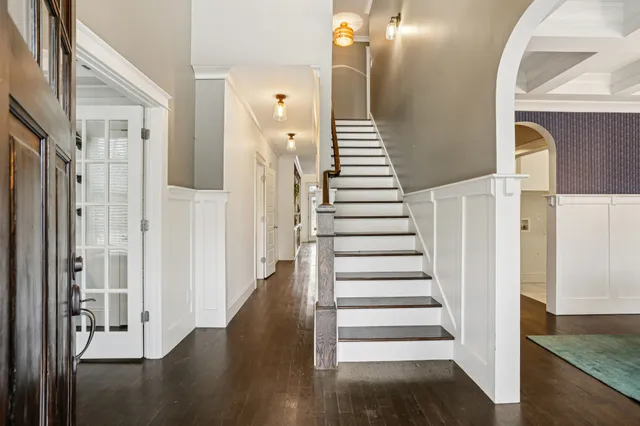 a view of a hallway with wooden floor and entryway