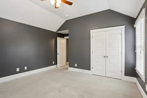 an empty room with windows and closet