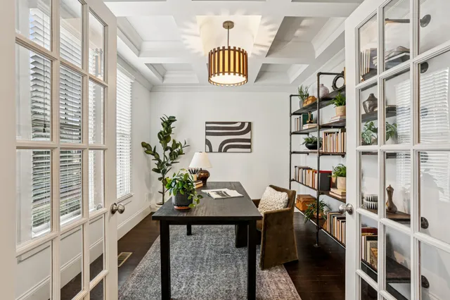 a view of hall way with furniture and chandelier