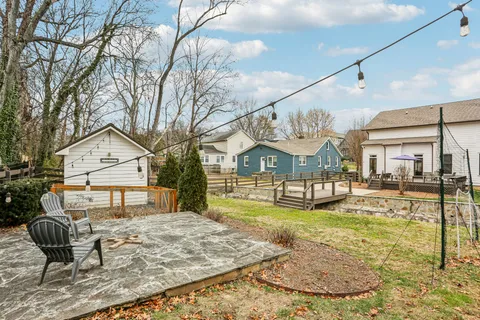 a view of a house with a backyard and a patio