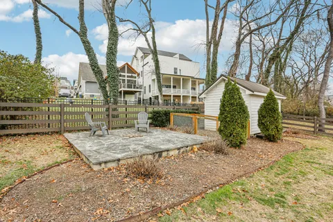 a view of a yard with iron fence