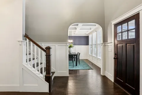 a view of entryway and hall with wooden floor