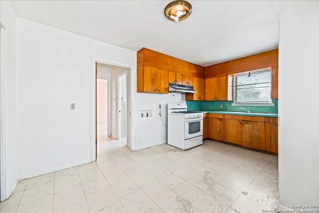 a kitchen with stainless steel appliances a refrigerator and a stove