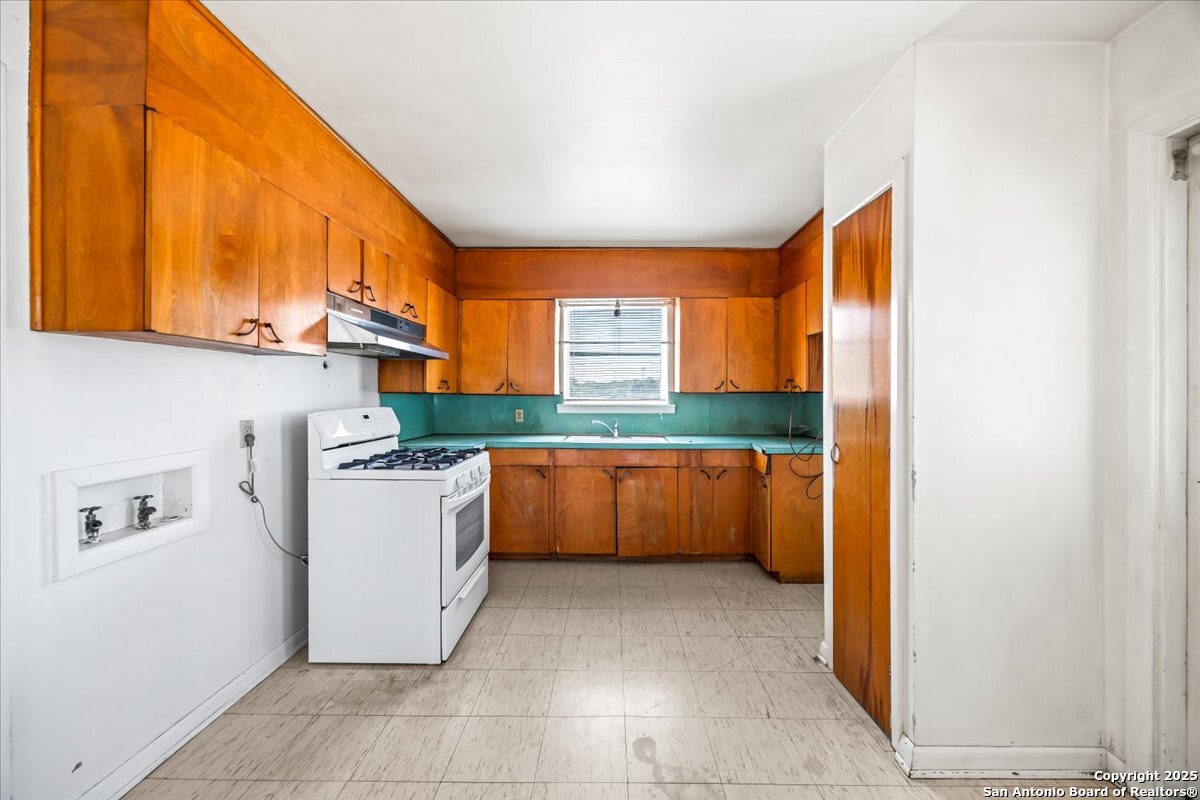 19239 McDonald Street Lytle, TX 78052 - Photo 12 of 29 a kitchen with a refrigerator and a stove