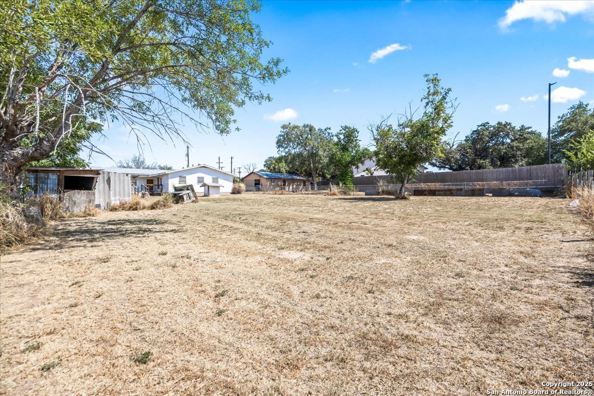 19239 McDonald Street Lytle, TX 78052 - Photo 20 of 29 a view of a yard with a tree
