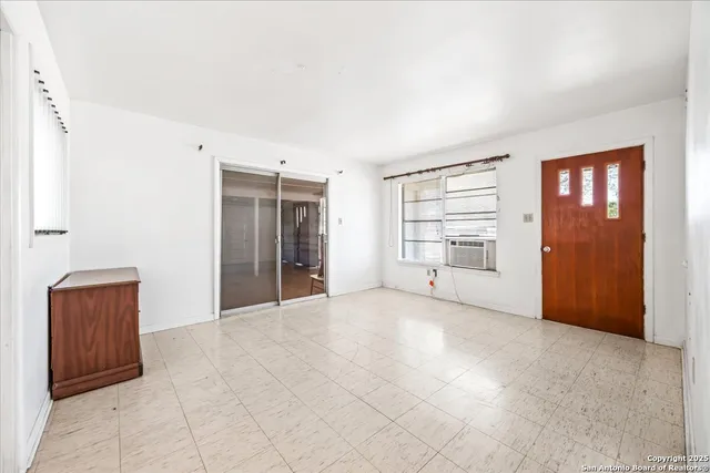 an empty room with a empty space and windows