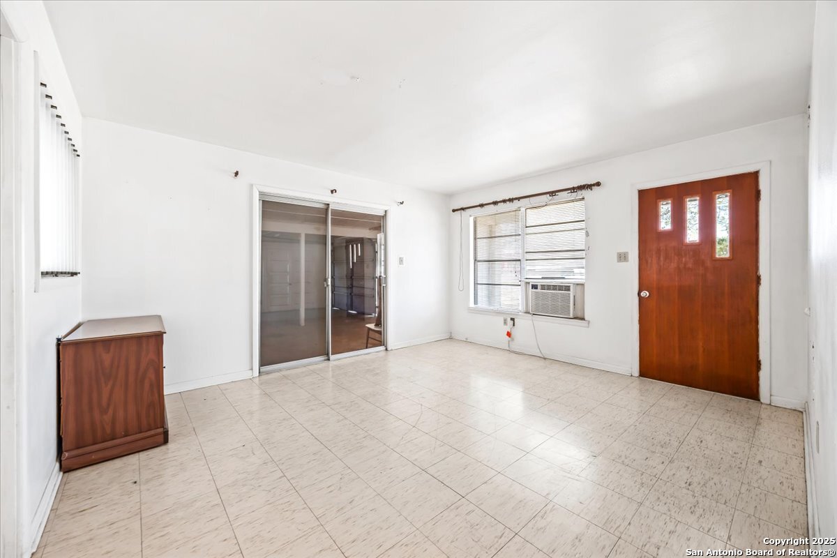 19239 McDonald Street Lytle, TX 78052 - Photo 7 of 29 an empty room with a empty space and windows