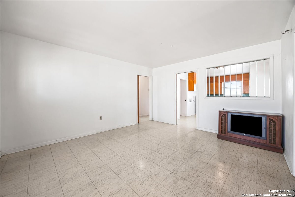 19239 McDonald Street Lytle, TX 78052 - Photo 8 of 29 an empty room with windows