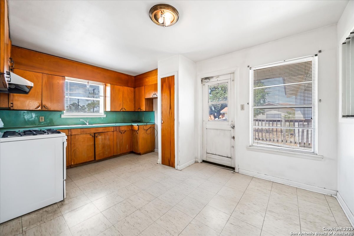 19239 McDonald Street Lytle, TX 78052 - Photo 9 of 29 a view of a kitchen with an empty room and a window