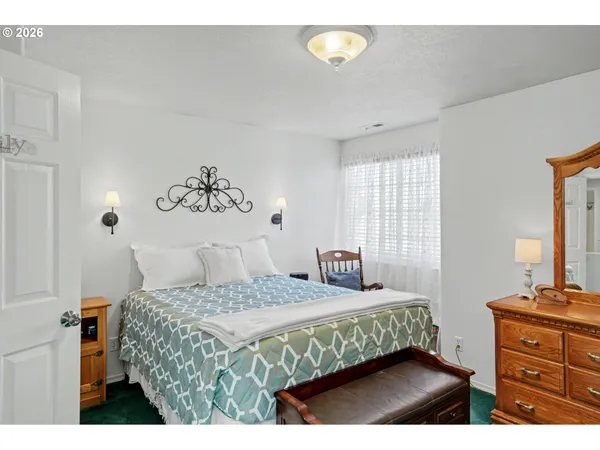 a bedroom with a bed and a dresser