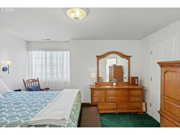a bedroom with a bed and a dresser