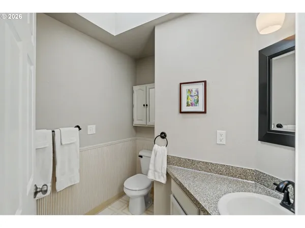 a bathroom with a sink a toilet and a mirror