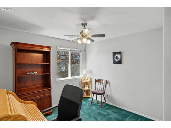 a bedroom with furniture and a window