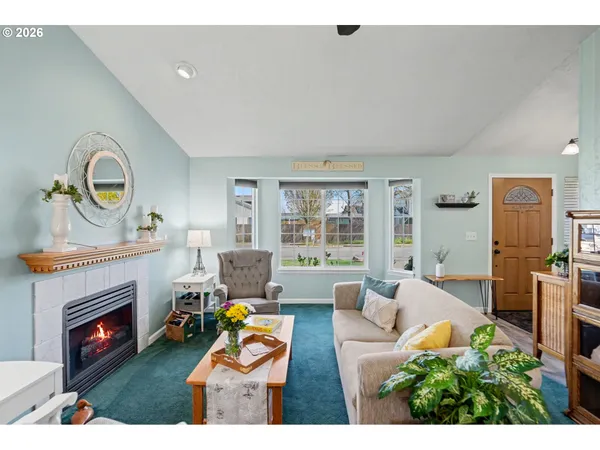 a living room with furniture a fireplace and a floor to ceiling window