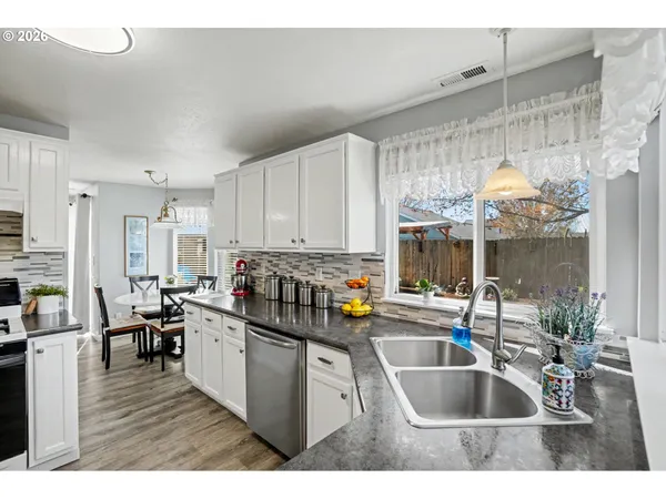 a kitchen with a sink stove and cabinets