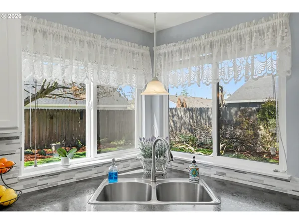 a kitchen view with a sink and table chair