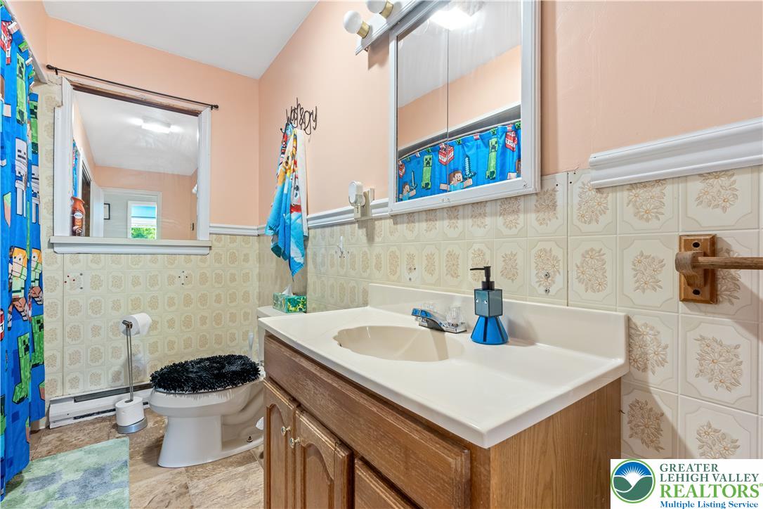 50 Kohls Road Northampton, PA 18067 - Photo 27 of 54 A well-maintained bathroom with tiled walls and practical vanity storage.