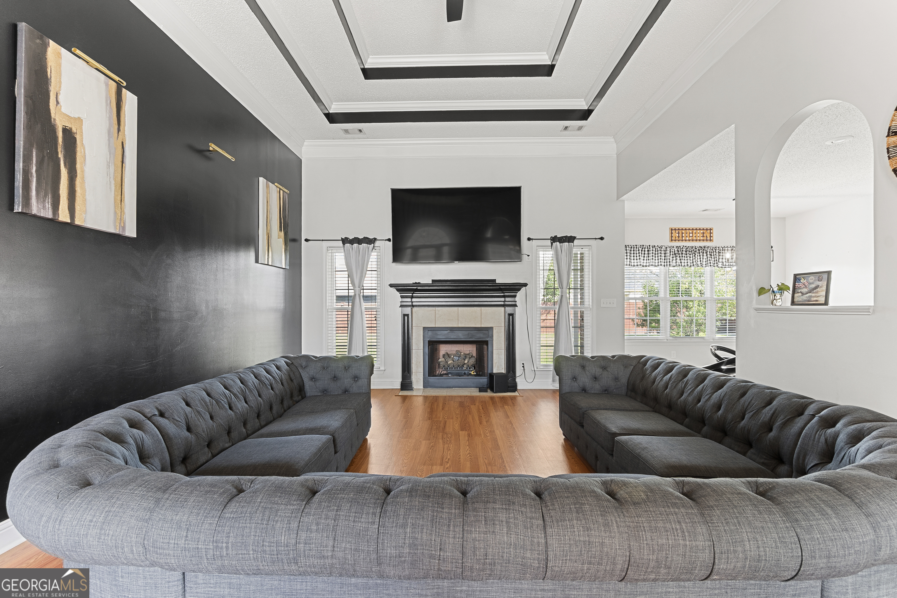 217 Caleb Way Byron, GA 31008 - Photo 11 of 58 a living room with furniture a flat screen tv and a fireplace