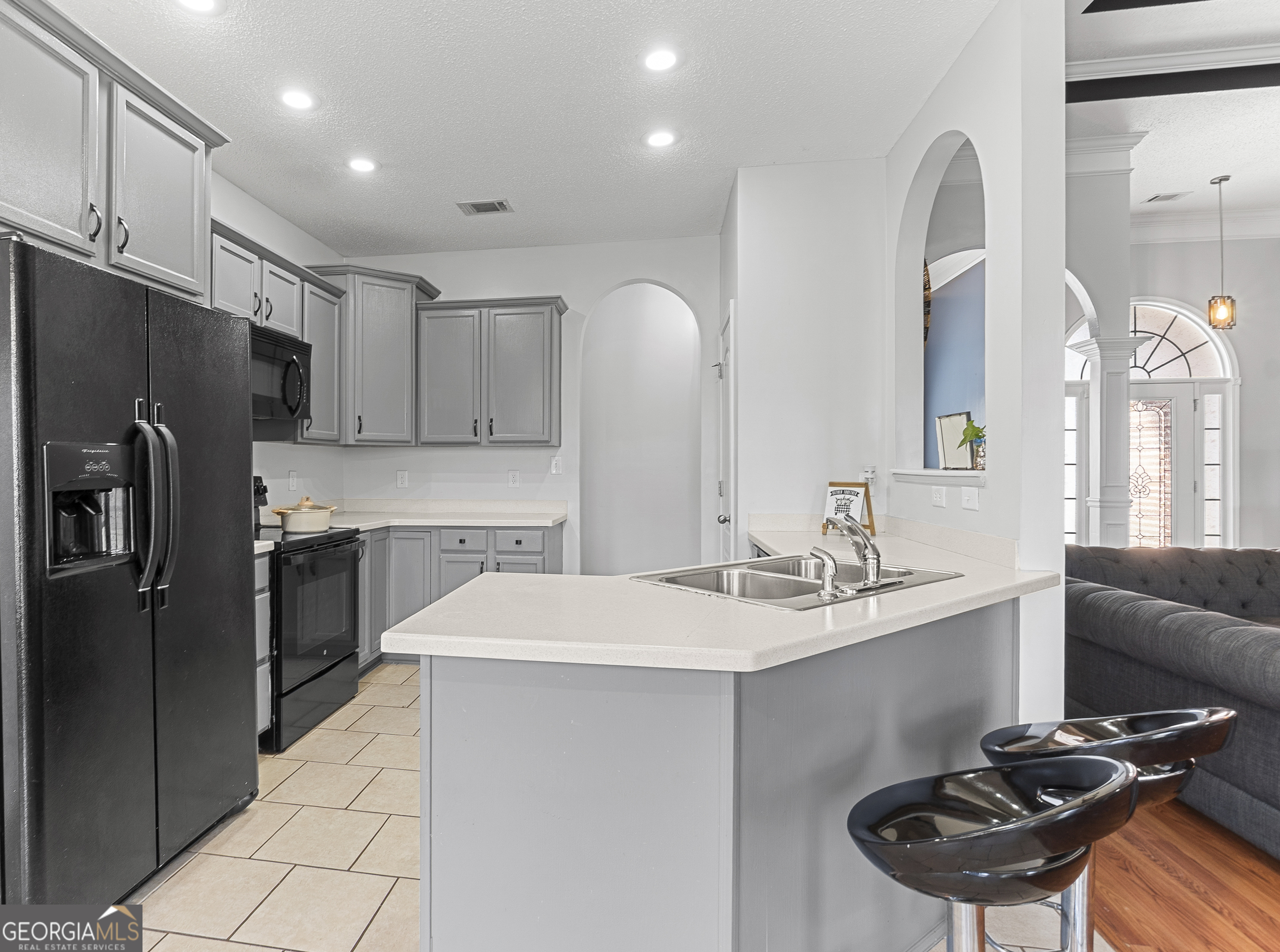 217 Caleb Way Byron, GA 31008 - Photo 20 of 58 a kitchen with stainless steel appliances a sink a stove a refrigerator cabinets and a dining table