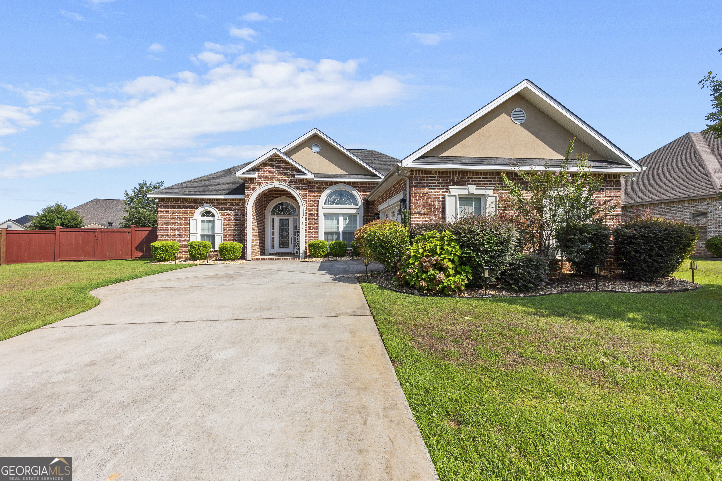 217 Caleb Way Byron, GA 31008 - Photo 2 of 58 a front view of a house with a yard and garage