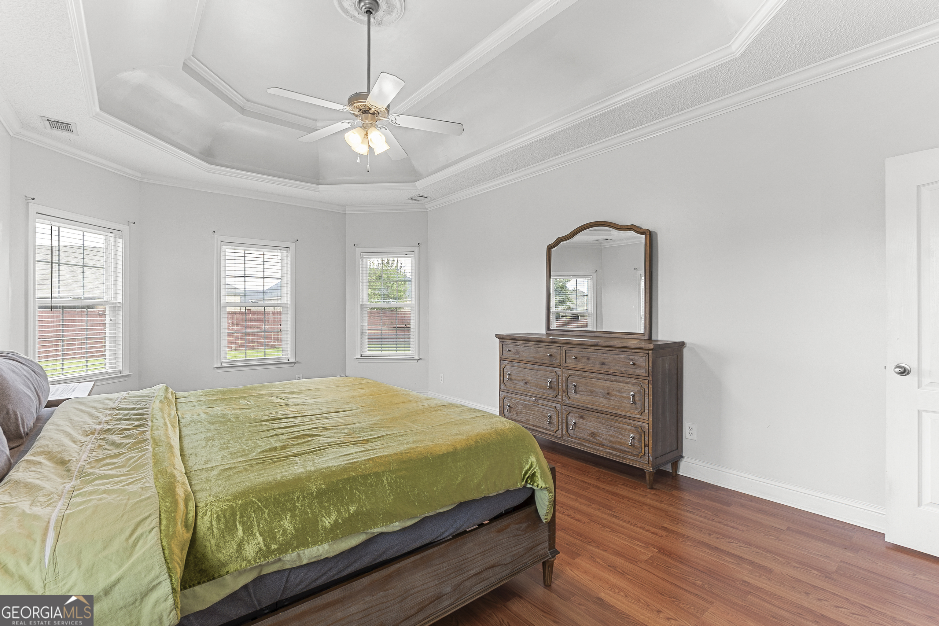 217 Caleb Way Byron, GA 31008 - Photo 27 of 58 a bedroom with a bed and wooden floor