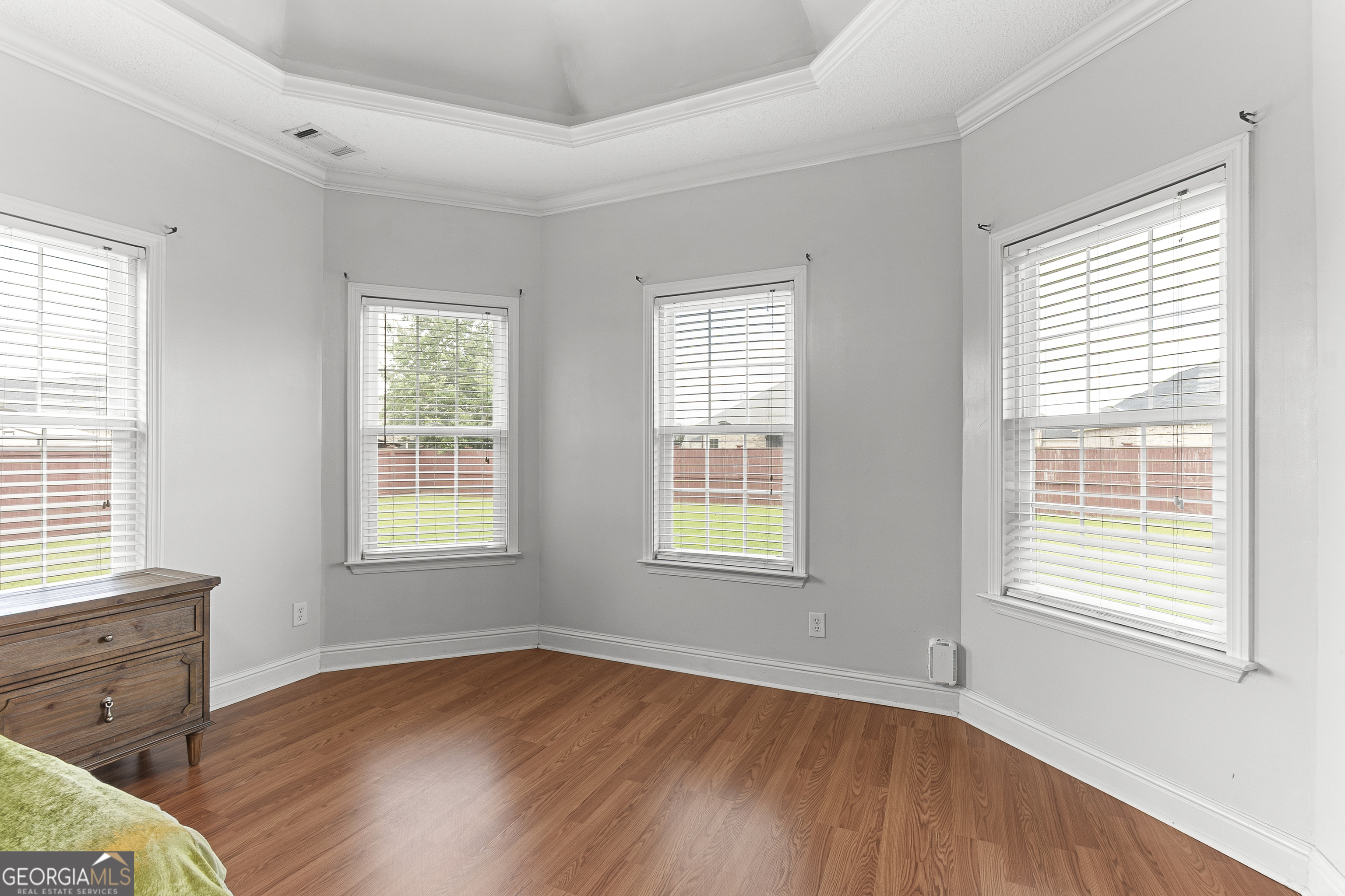 217 Caleb Way Byron, GA 31008 - Photo 28 of 58 a view of an empty room with wooden floor and a window