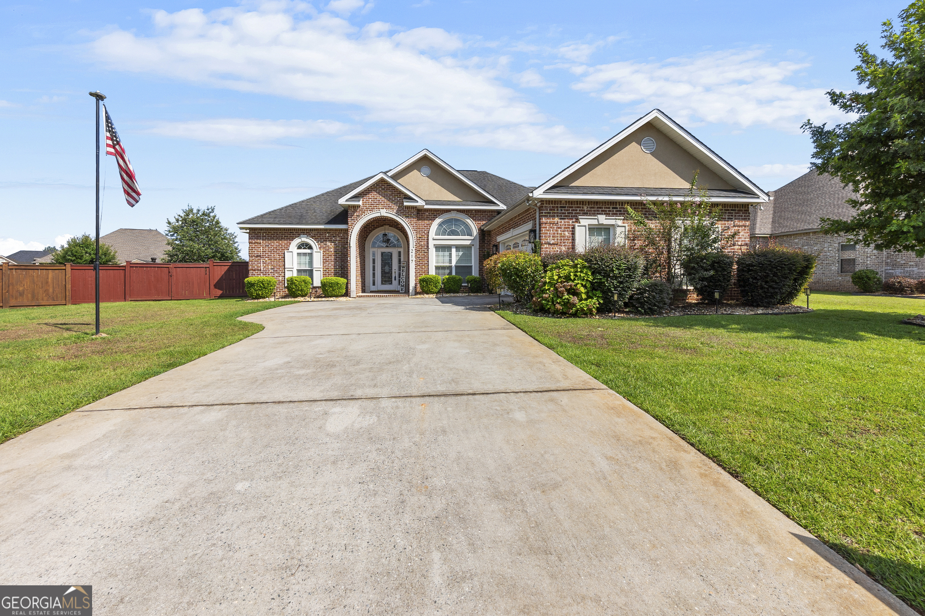 217 Caleb Way Byron, GA 31008 - Photo 3 of 58 a front view of a house with a yard and garage