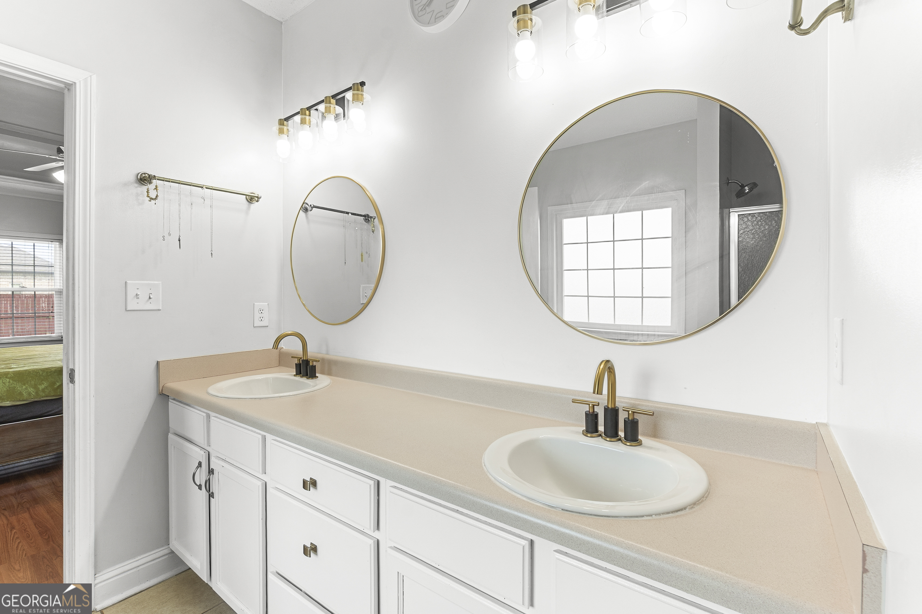 217 Caleb Way Byron, GA 31008 - Photo 32 of 58 a bathroom with 2 sink and a mirror