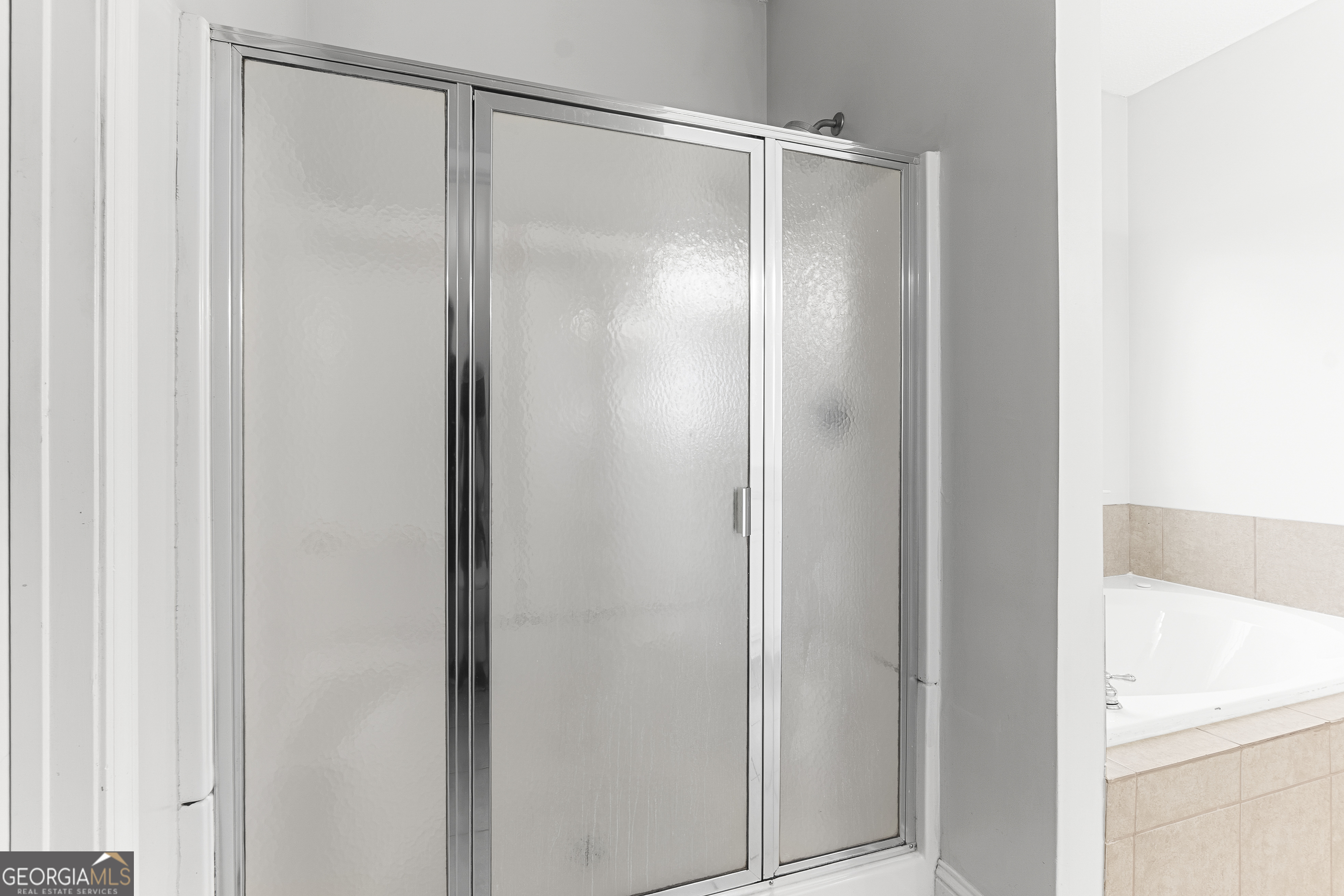 217 Caleb Way Byron, GA 31008 - Photo 34 of 58 a bathroom with a glass shower door