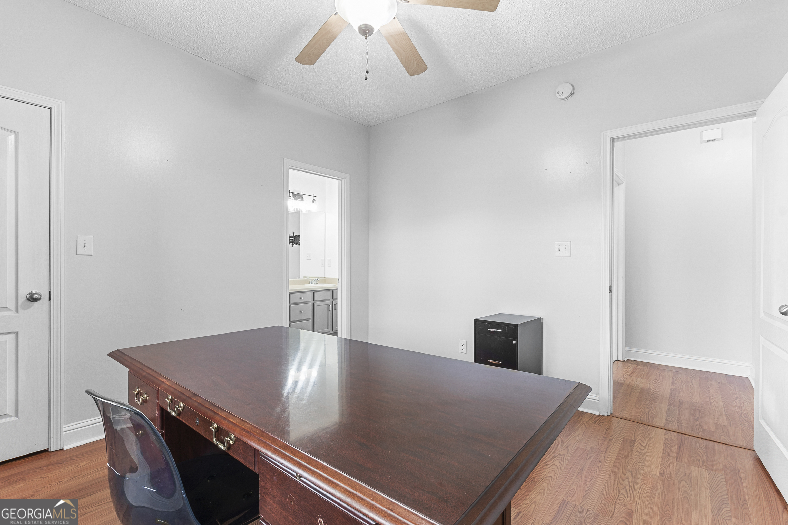 217 Caleb Way Byron, GA 31008 - Photo 38 of 58 a living room with a bed furniture and a wooden floor