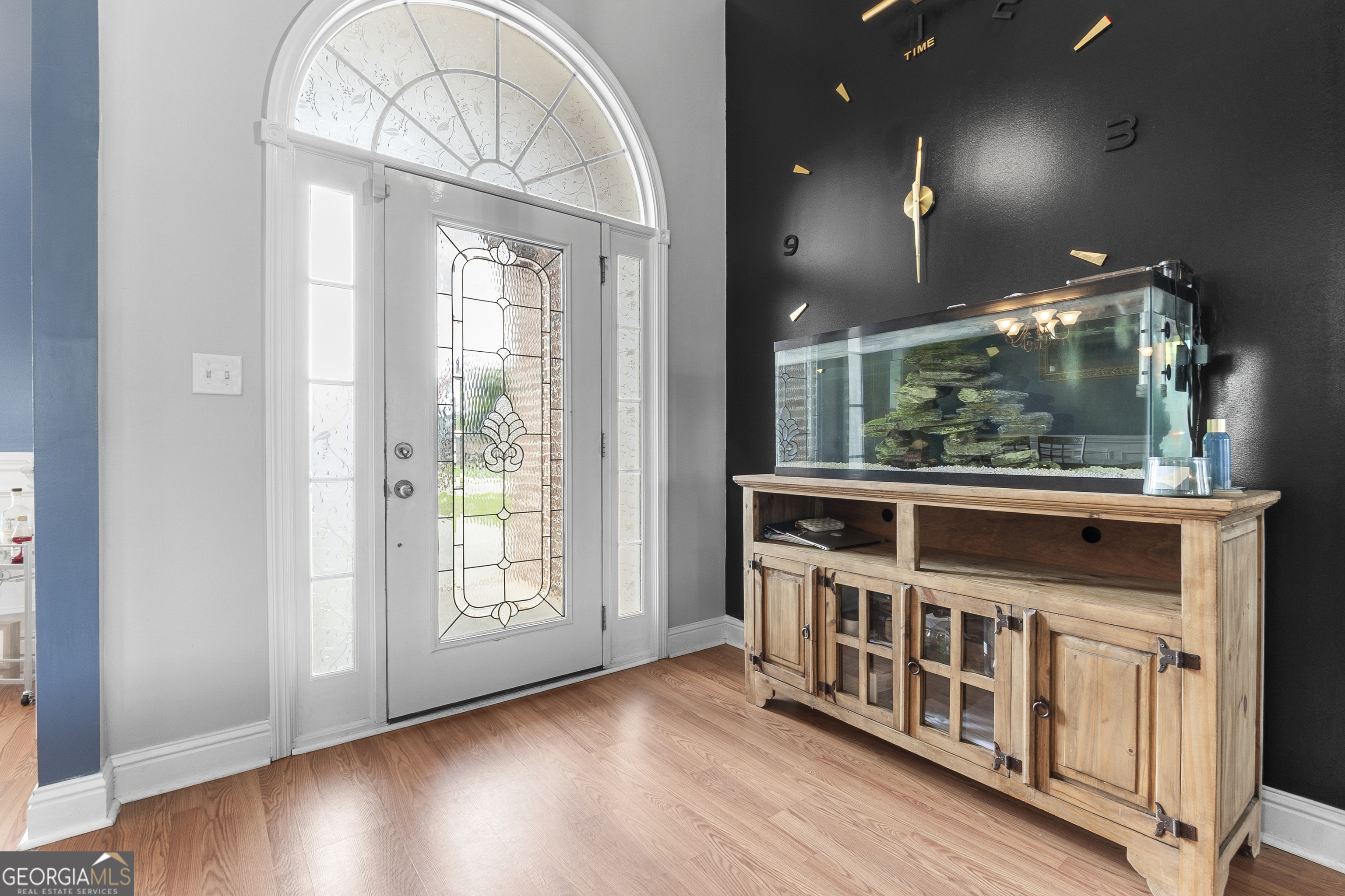 217 Caleb Way Byron, GA 31008 - Photo 6 of 58 an empty room with wooden floor fan and windows