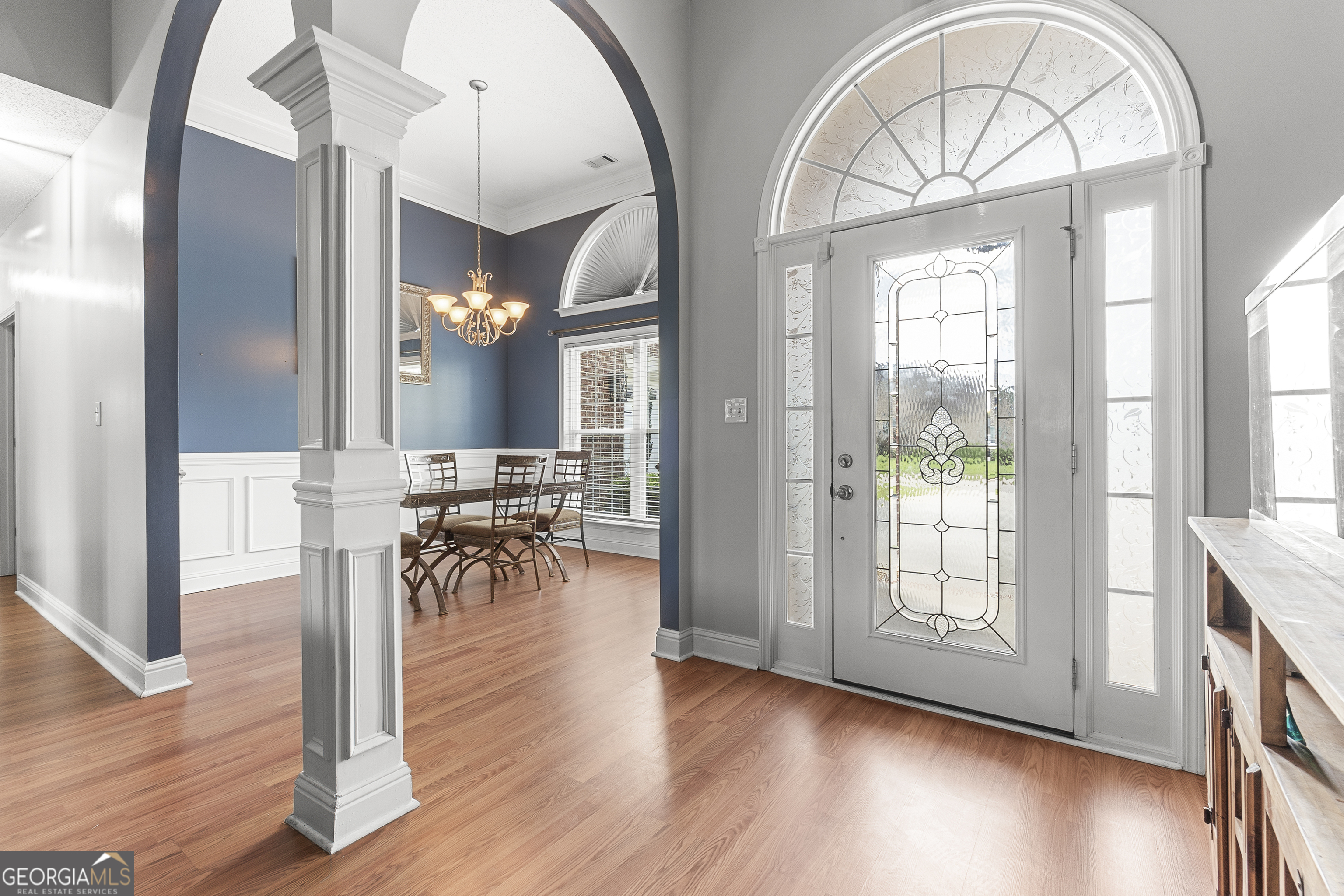 217 Caleb Way Byron, GA 31008 - Photo 7 of 58 a view of hall way with dining room and chandelier with wooden floor