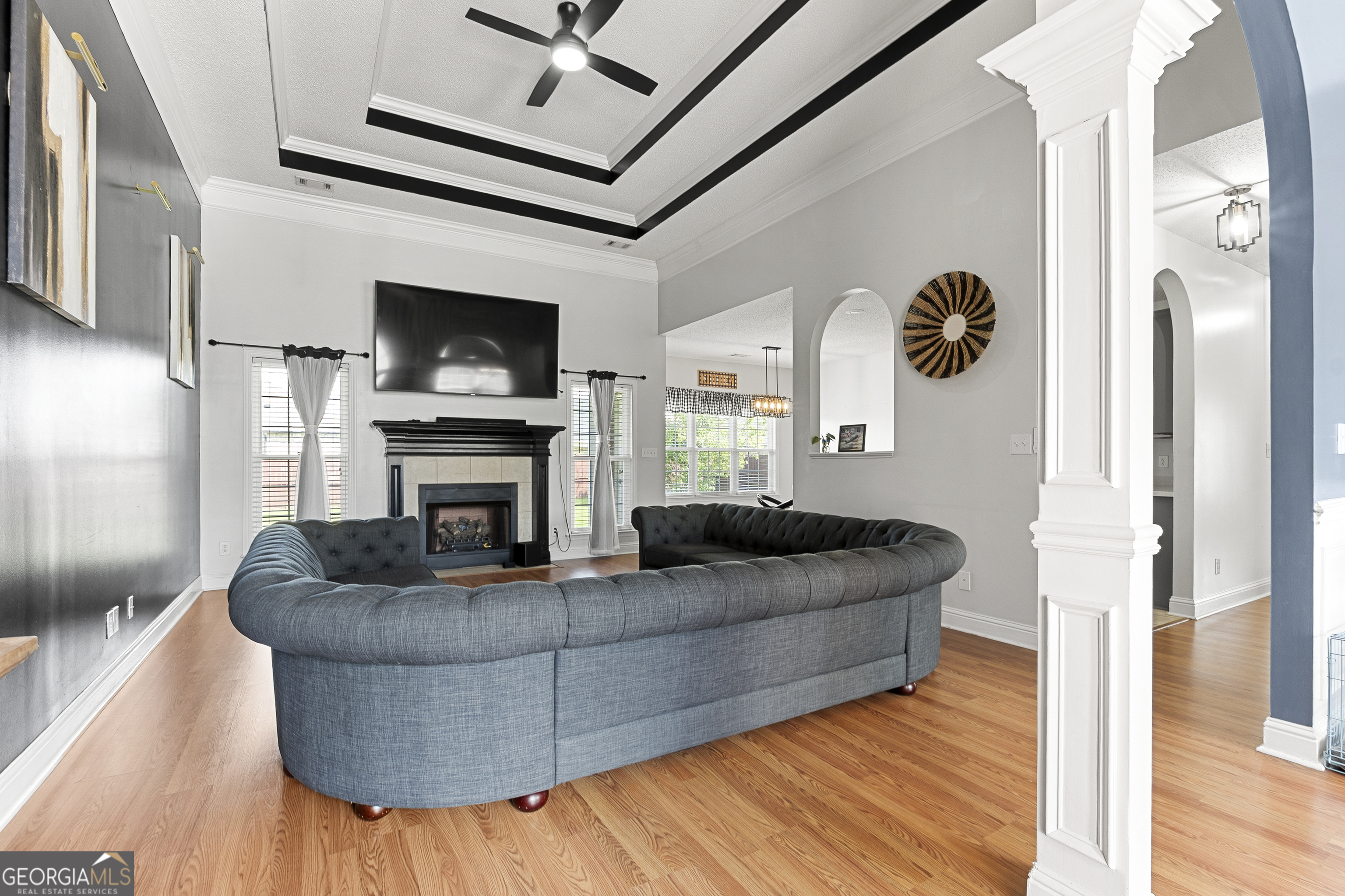 217 Caleb Way Byron, GA 31008 - Photo 9 of 58 a living room with furniture a flat screen tv and a fireplace
