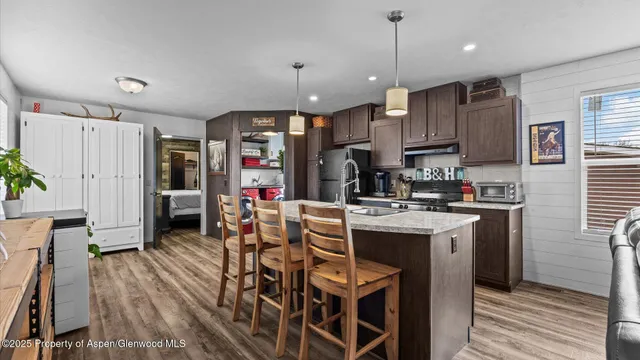 a kitchen that has a lot of cabinets a sink a window and stainless steel appliances