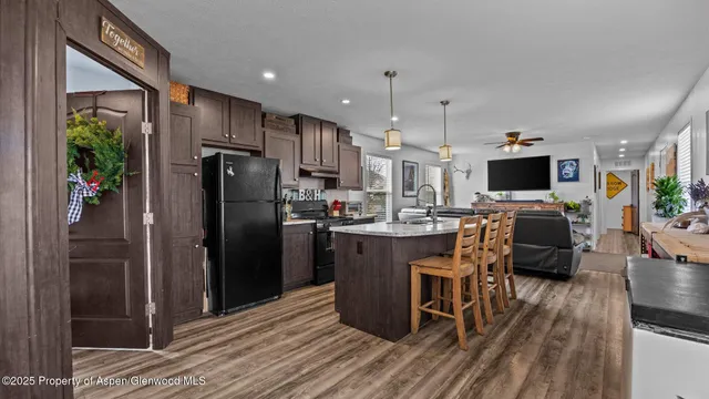 a kitchen with stainless steel appliances a refrigerator stove microwave and sink