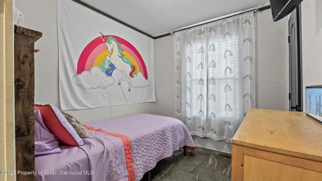 a bedroom with a bed and a painting on the wall