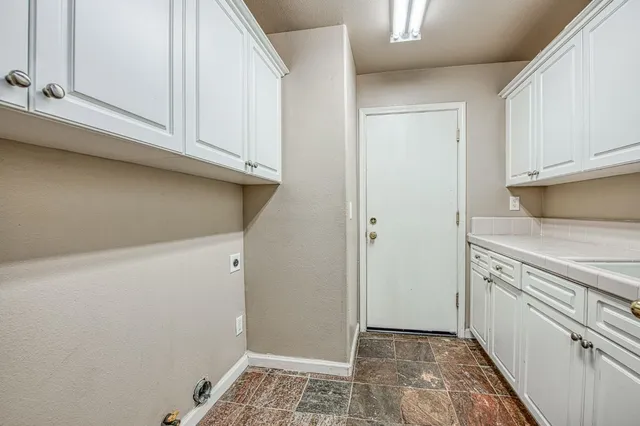 a view of a kitchen with white cabinets