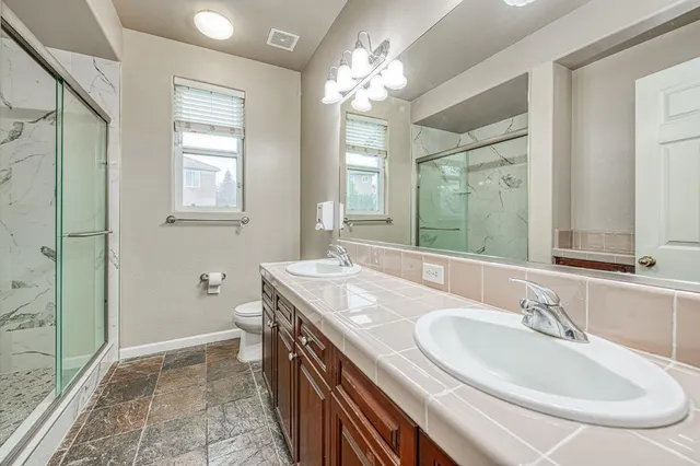 a bathroom with a sink double vanity and a mirror